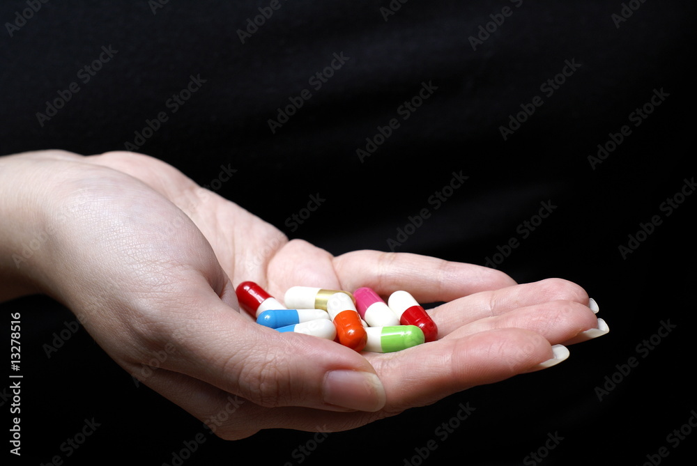 Female hand with colorful pills Female hand with colorful pills
