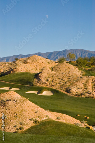 Desert golf course with day moon