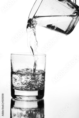 Quadro em tela Water jug pouring into glass