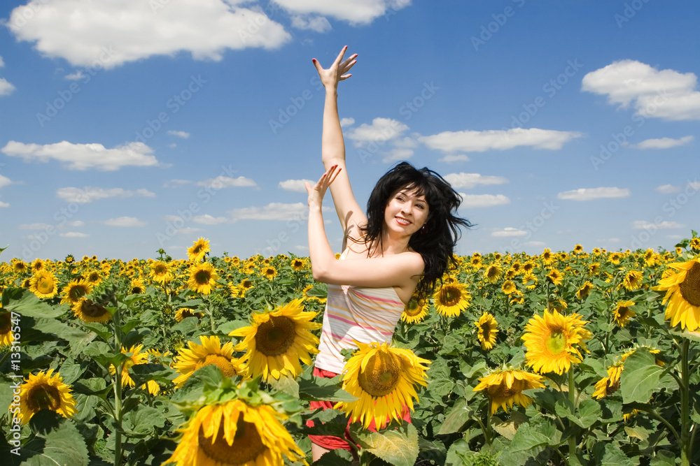 fun woman in the field of sunflowers fun woman in the field of sunflowers