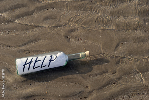 Help written on paperin a bottle photo