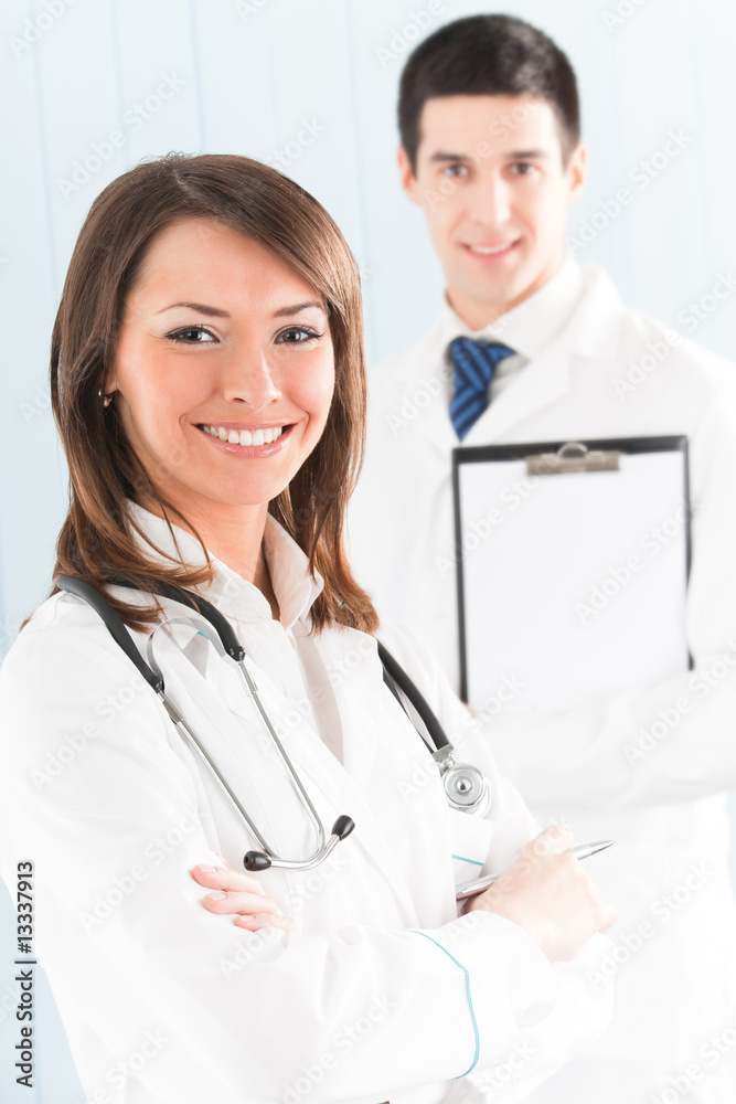 Fototapeta premium Portrait of two happy smiling medical people at office