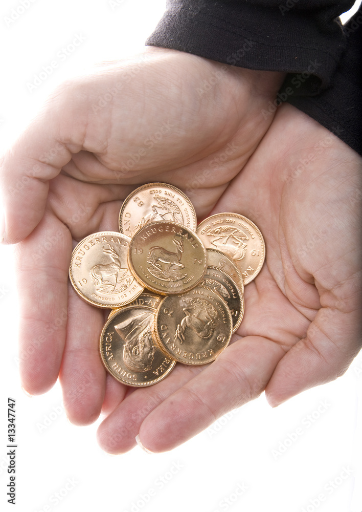 Hands full gold Krugerrand coins from South Africa Hands full gold Krugerrand coins from South Africa