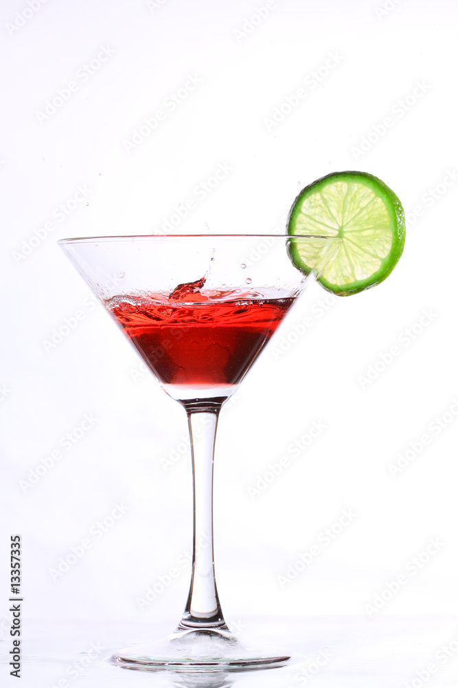red cocktail with lime on white