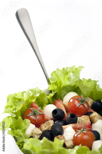 Fresh Greek salad with olives, mozzarella cheese, tomatoes, onio