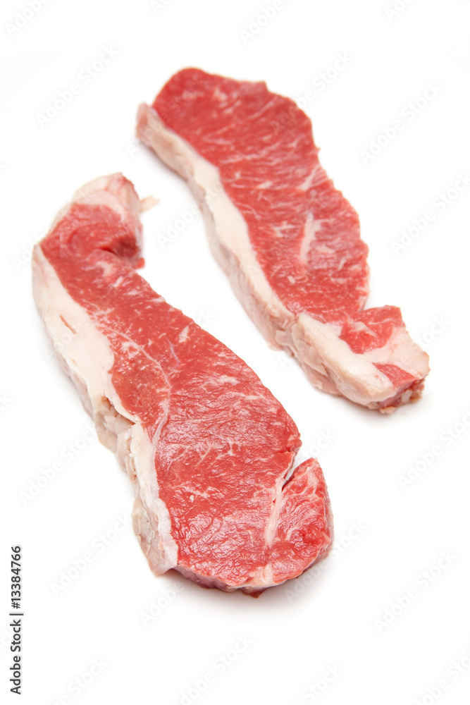 Steak isolated on a white studio background. Steak isolated on a white studio background.
