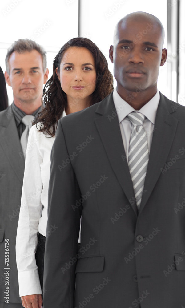 Serious Business man looking at camera with group in background Serious Business man looking at camera with group in background