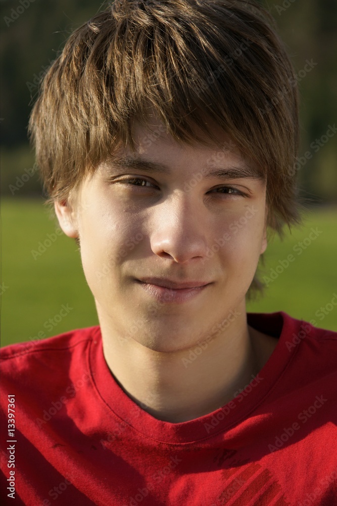 A portrait of a handsome teen boy outside. A portrait of a handsome teen boy outside.