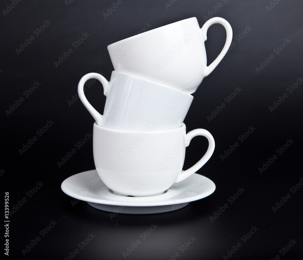 Three cups of white on a black background