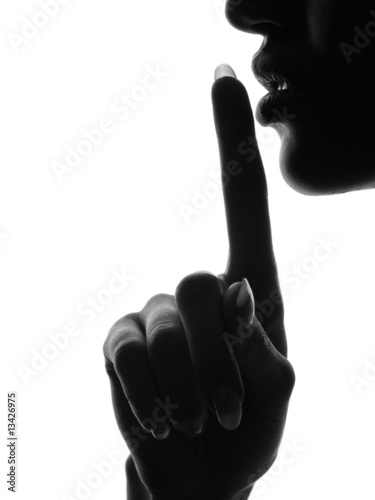 Foto Finger over mouth gesture requesting silence.