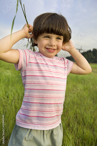 little cute pensive girl five years old standing on  park photo