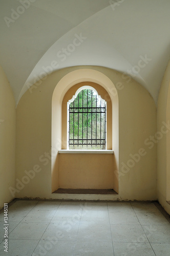 Catholic religious construction. Metal lattice at a window © Severas