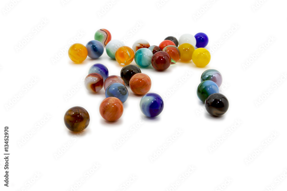 Fototapeta premium Marbles spread on white