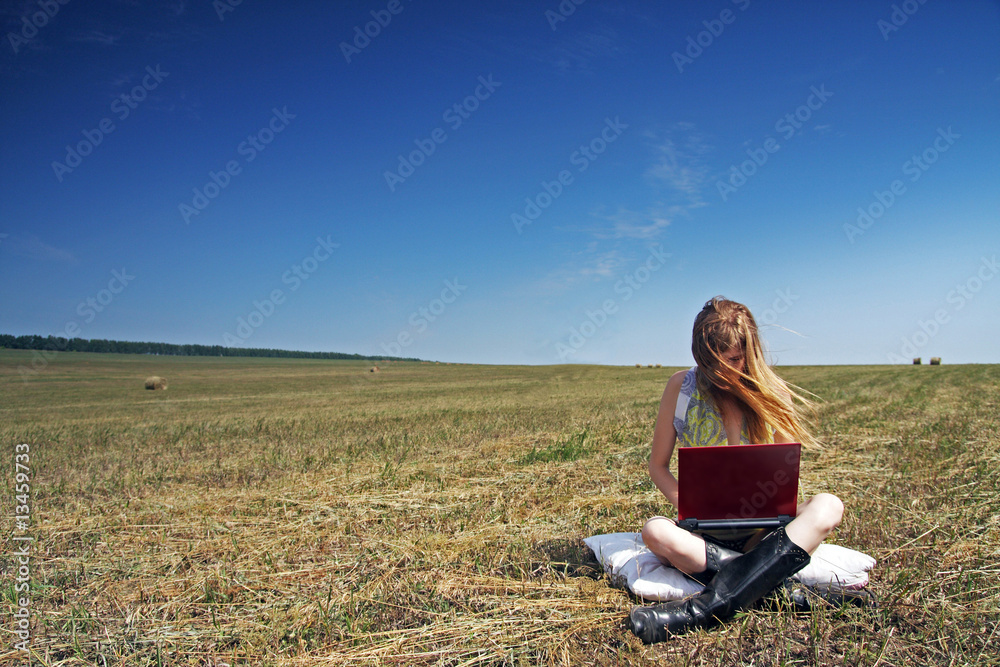 The girl from laptops on a grass in the autumn. The girl from laptops on a grass in the autumn.