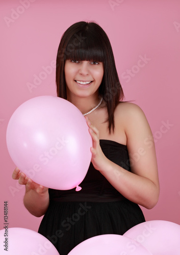 girl holding a pink balloon