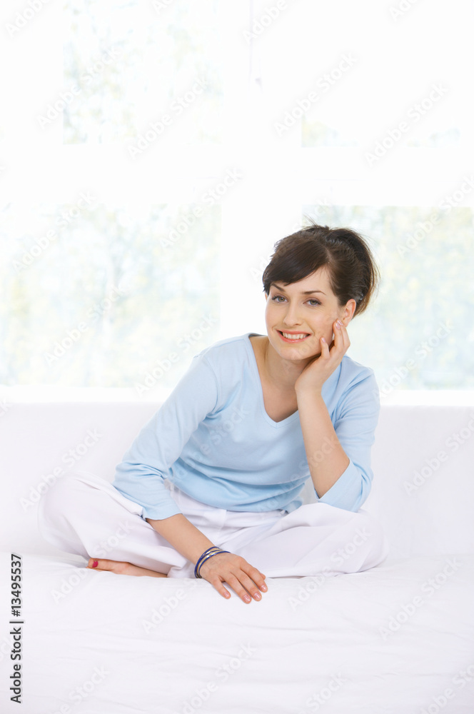 Young woman relaxing on couch in her home Young woman relaxing on couch in her home