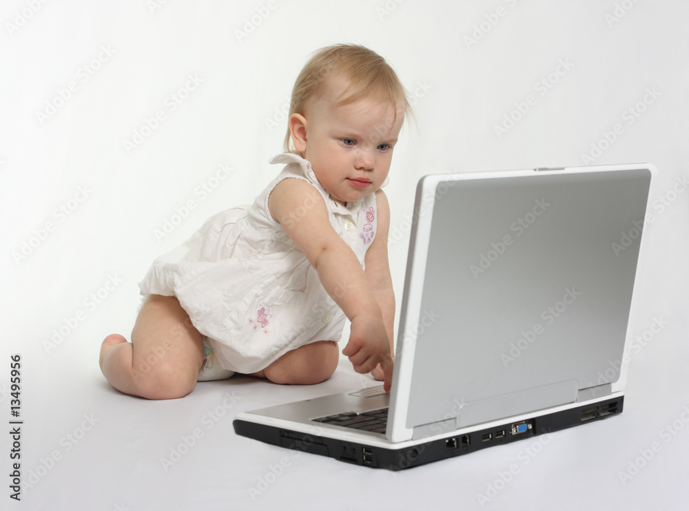 little girl pressing the button on the laptop little girl pressing the button on the laptop