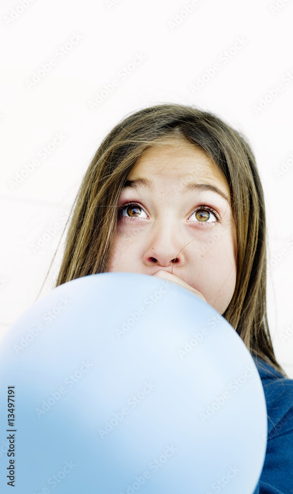 Adorable young child blowing balloon Adorable young child blowing balloon
