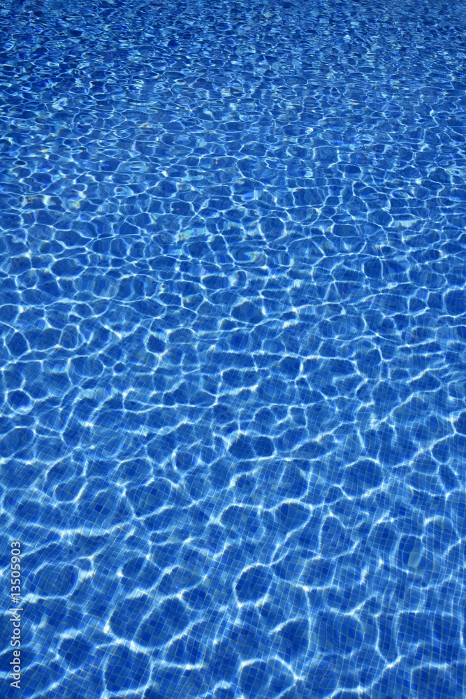 Blue water texture, tiles pool in sunny day Blue water texture, tiles pool in sunny day