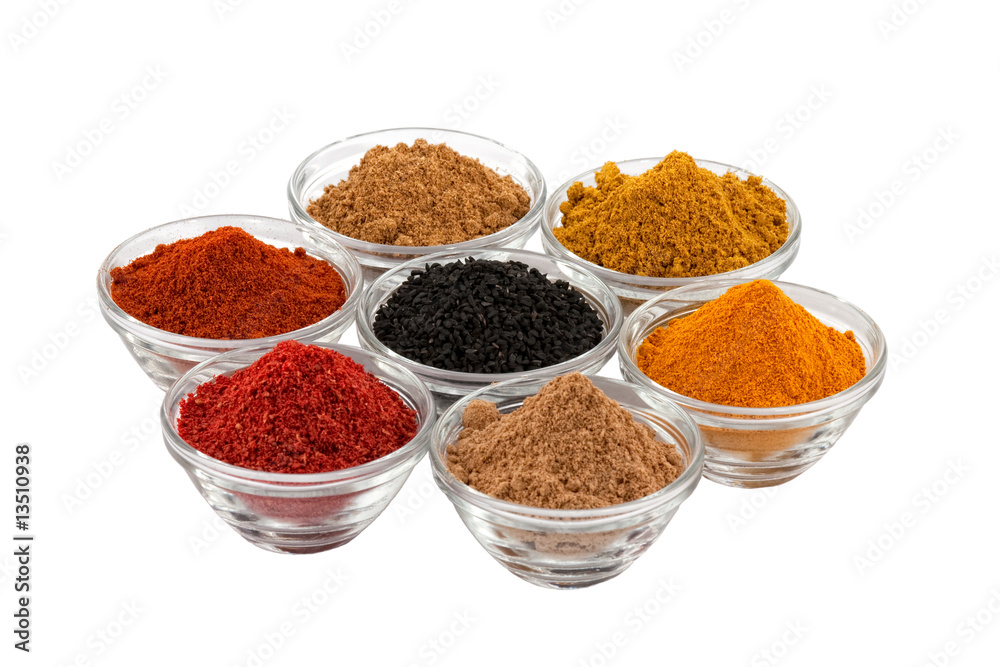 several indian spices in glass bowls several indian spices in glass bowls