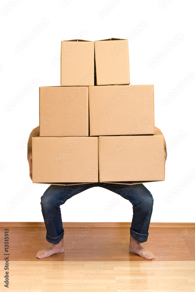 Man struggling while lifting lots of cardboard boxes Man struggling while lifting lots of cardboard boxes