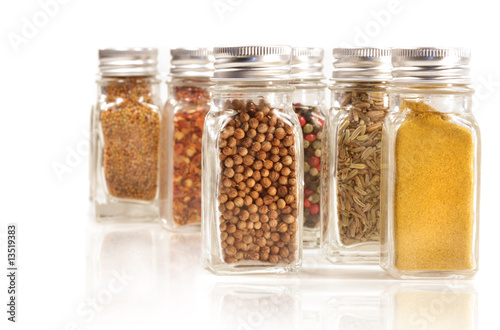 Assorted spice jars isolated on white