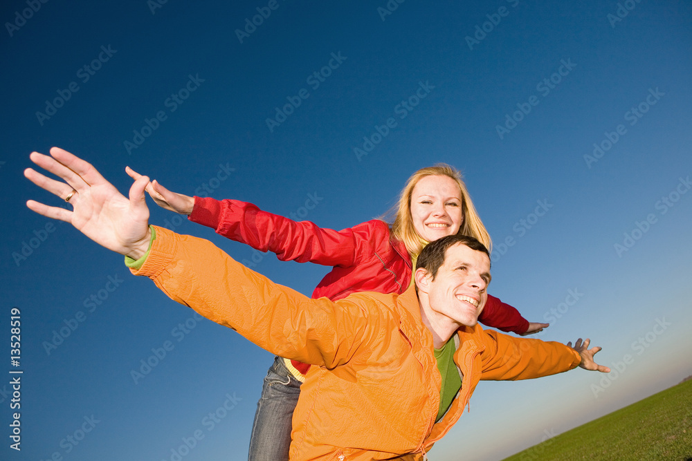 Happy smiling couple fly in sky
