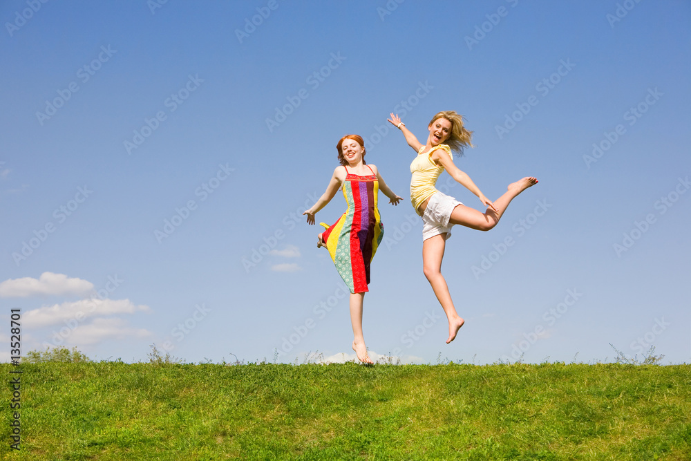 Two happy girls jumping