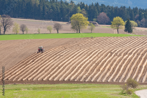 фотографія tractor plowing filed