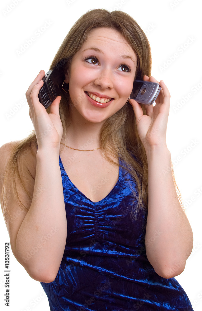 smiling girl in blue dress with two cellular phones smiling girl in blue dress with two cellular phones