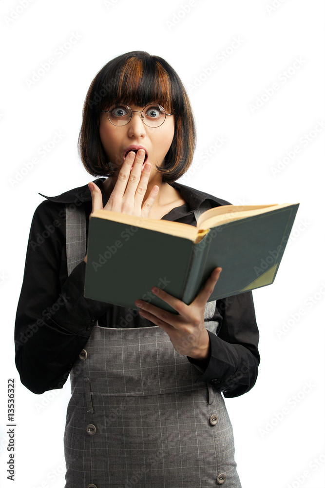 Surprised brunette schoolgirl looking front and hold book Surprised brunette schoolgirl looking front and hold book