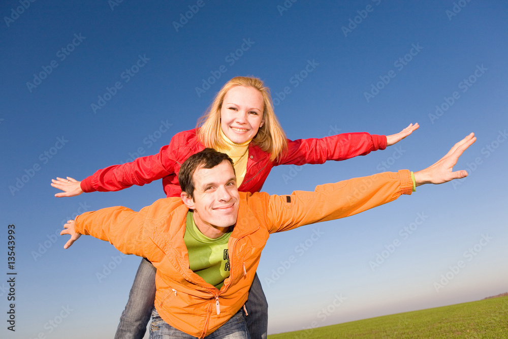 Happy smiling couple fly in sky