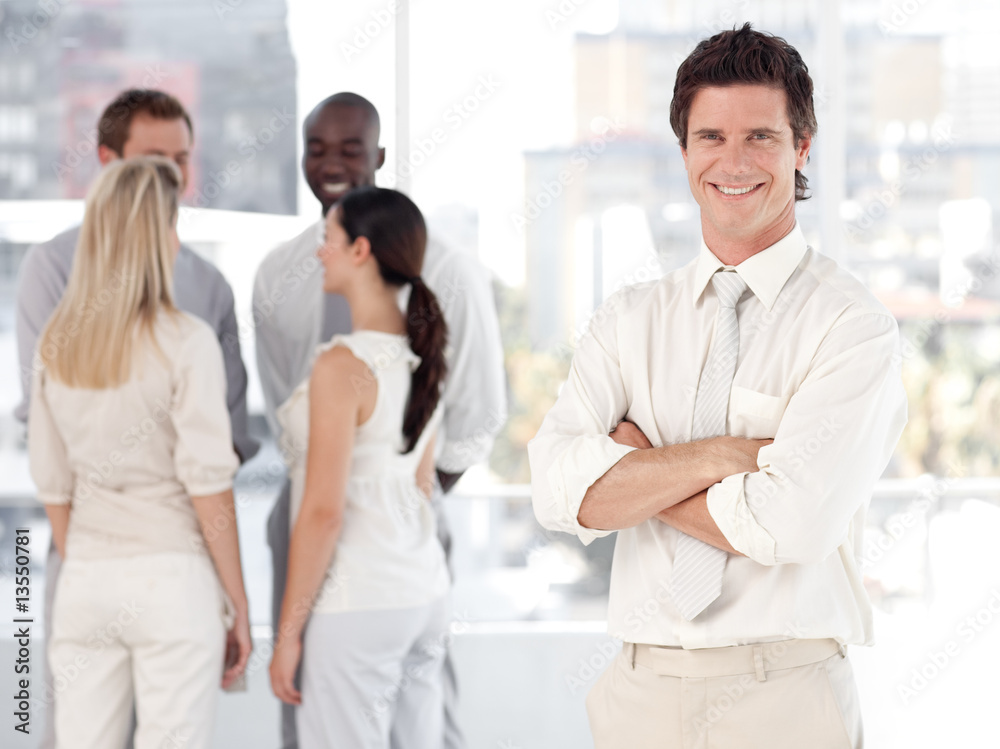 Young Business man Smiling in Front of Business team Young Business man Smiling in Front of Business team