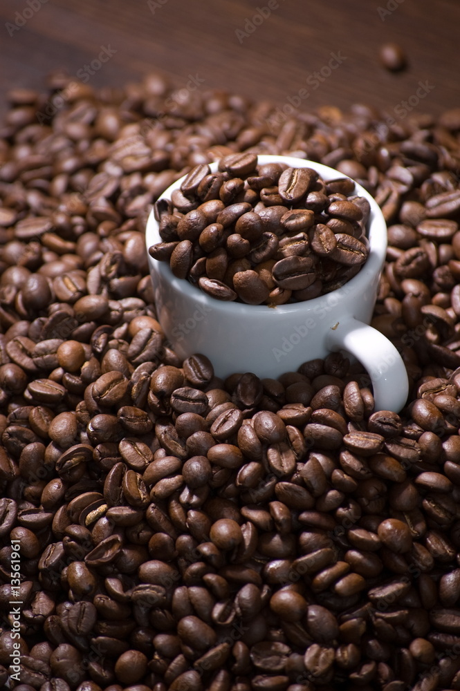 White cup full of coffee beans