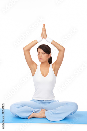 Fototapeta Naklejka Na Ścianę i Meble -  Young woman doing yoga exercise on mat