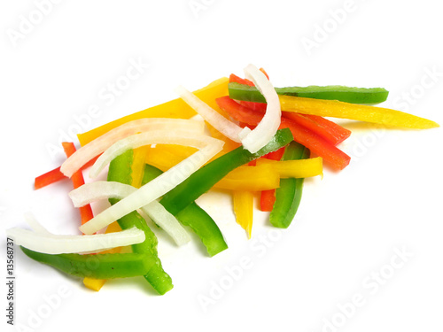 Sliced peppers and onion in sticks, on white background