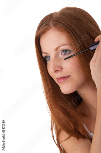 Body care series - Beautiful red hair woman applying mascara