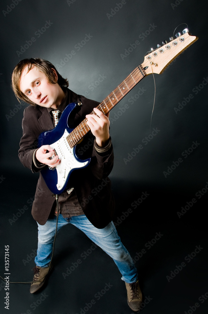 Obraz premium Young man playing electro guitar