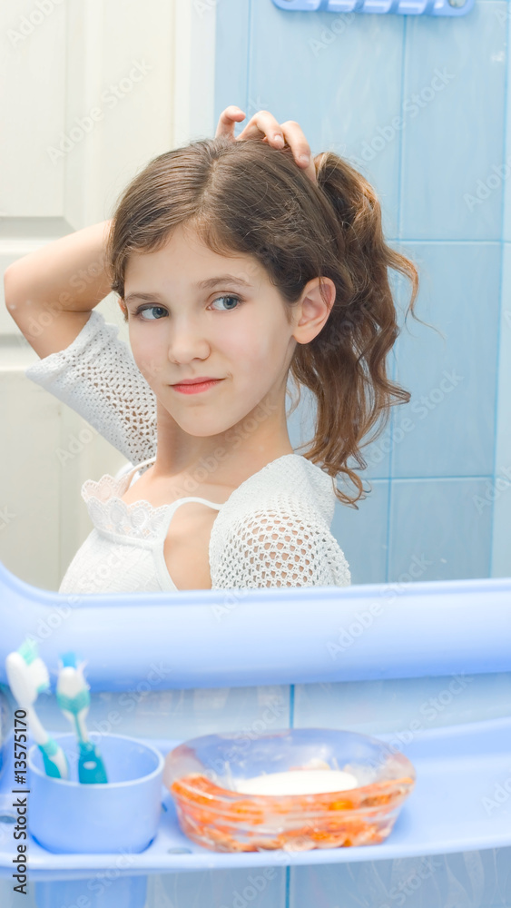 Teen girl in bathroom Stock Photo