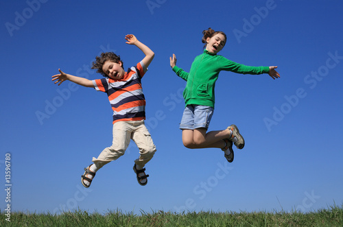 Kids jumping  running against blue sky