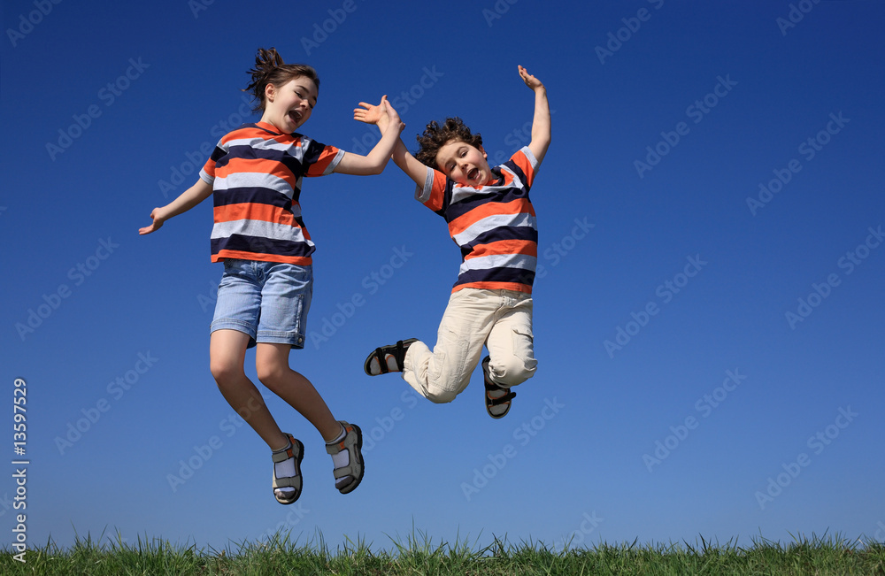 Kids jumping, running against blue sky Kids jumping, running against blue sky