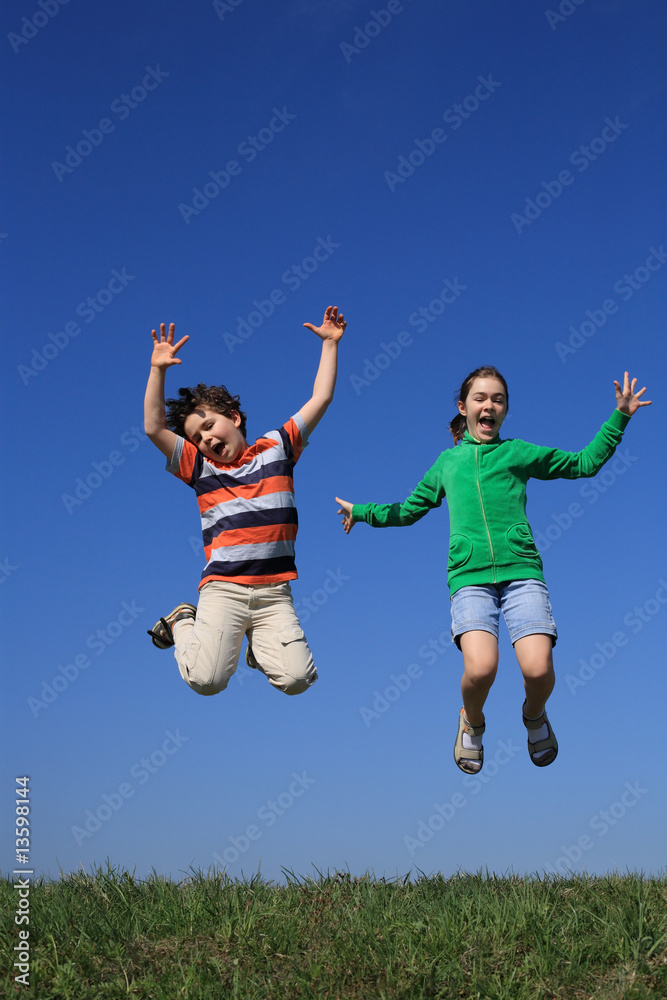 Kids jumping, running against blue sky Kids jumping, running against blue sky