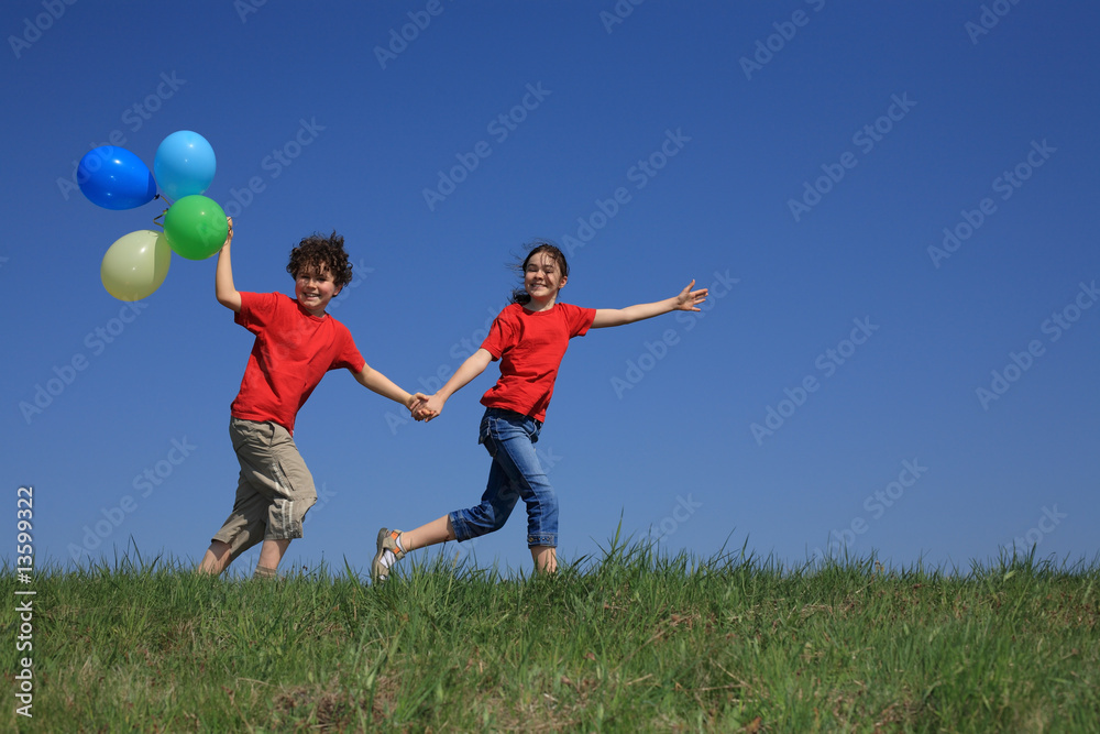 Kids holding balloons ,playing outdoor Kids holding balloons ,playing outdoor
