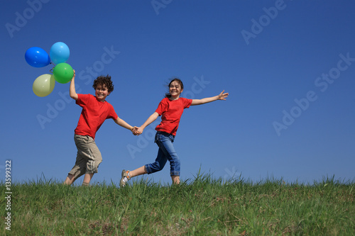 Kids holding balloons  playing outdoor