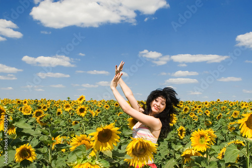 fun woman in the field of sunflowers