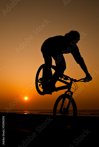 young man performing bike tricks
