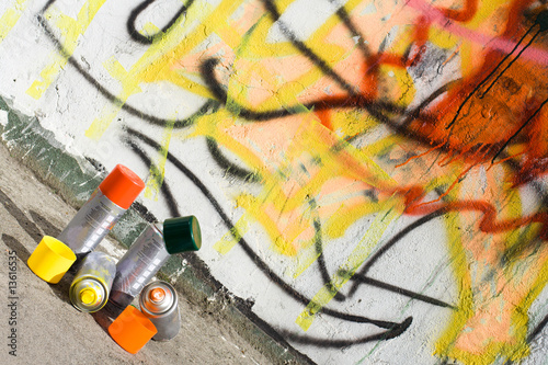 Aerosol paint near graffiti painted wall