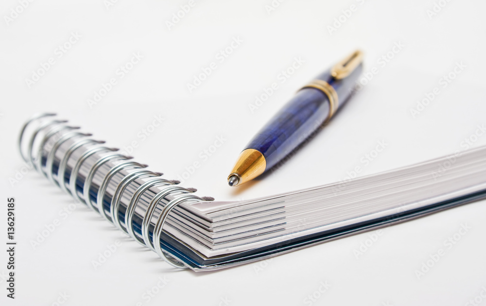 Pen on a white page of notebook Pen on a white page of notebook