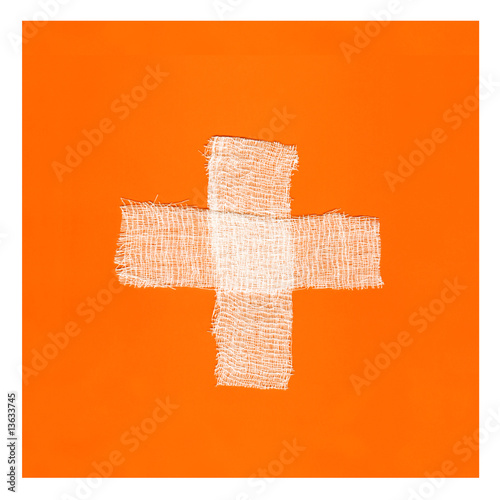 Two white bandages forming a cross on orange background