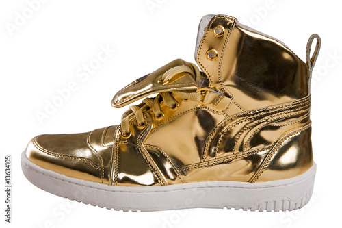 Golden sport shoes isolated on white